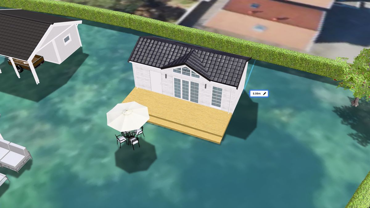 Vyn av en tomt i en interaktiv tomtkarta där ett hus, garage och flera 3D modeller har placerats ut